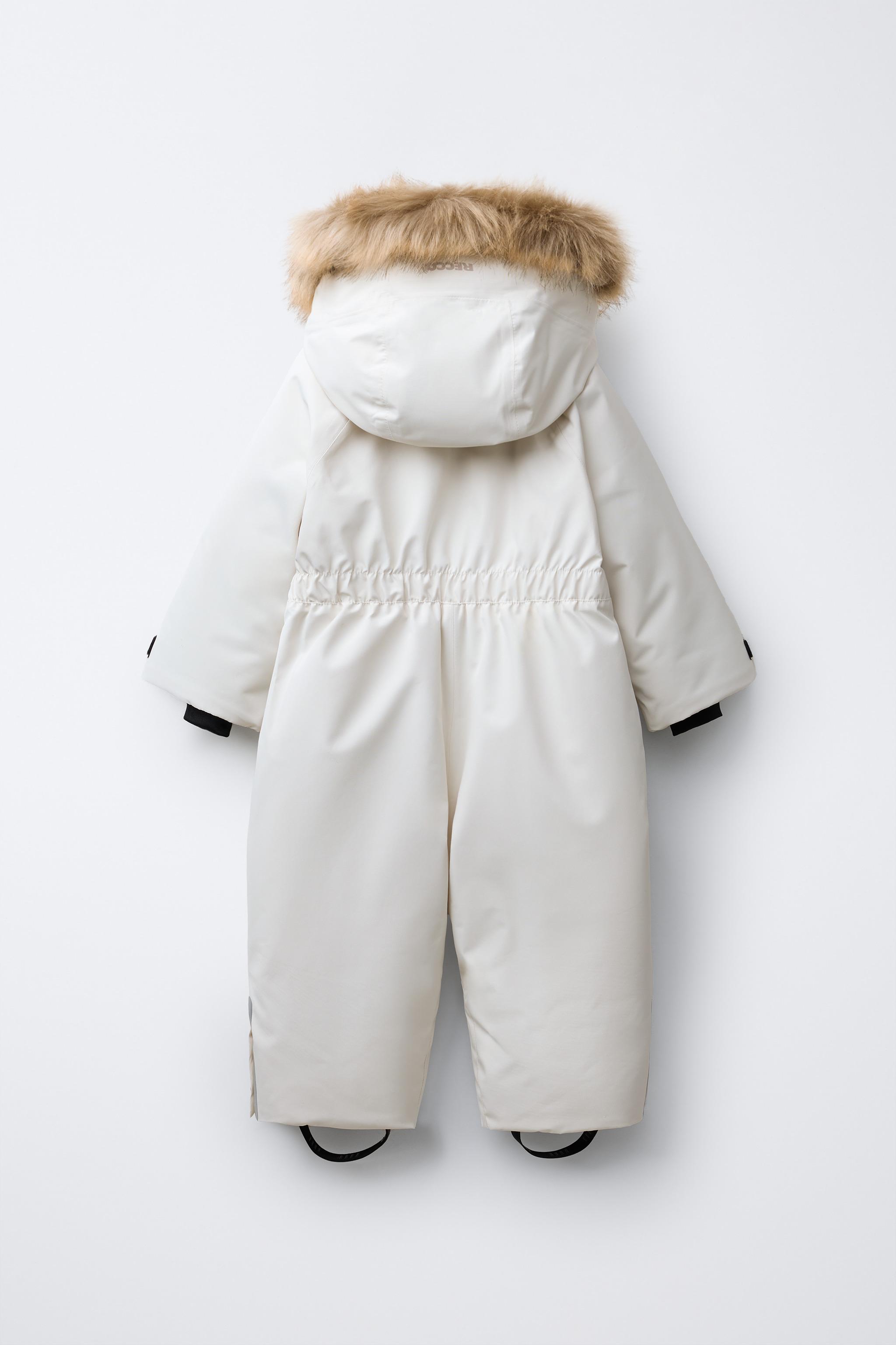 WATER RESISTANT AND WINDPROOF RECCO® SYSTEM SKI COLLECTION LONG JUMPSUIT WITH FAUX FUR HOODIE
